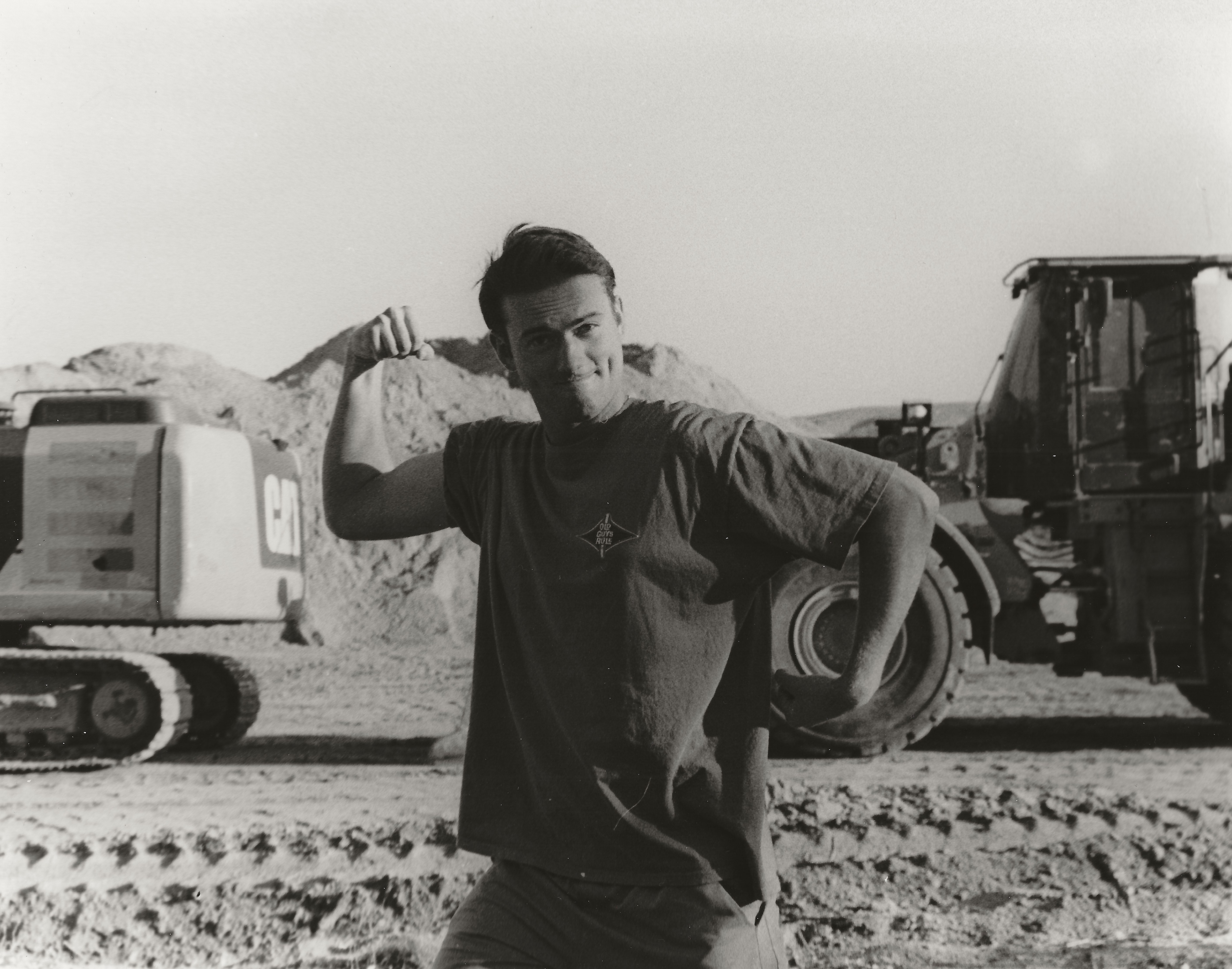 man posing in front of a truck