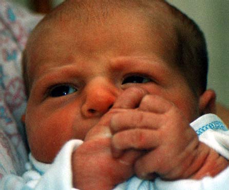 Baby Reagan pondering her hands and wondering what happens next?