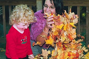 Reagan and Angie play in the autumn leaves