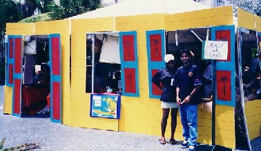 Makini and Varun in front of Haiti's booth