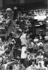 Kendrick Proctor goes up and over for a bucket (photo by Jason Wickman)