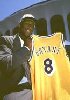 Kobe holding up his jersey