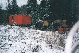 skidder pulling drill to Trainman
