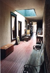 Hallway of second floor leads to many rooms filled with antiques and collectibles.