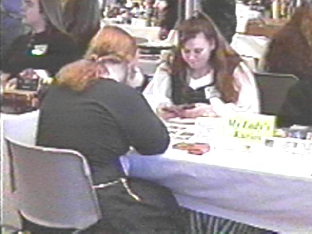 Erma Playing cards with a customer.