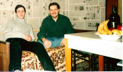 Photo of Brian and Host's friend sitting on bed