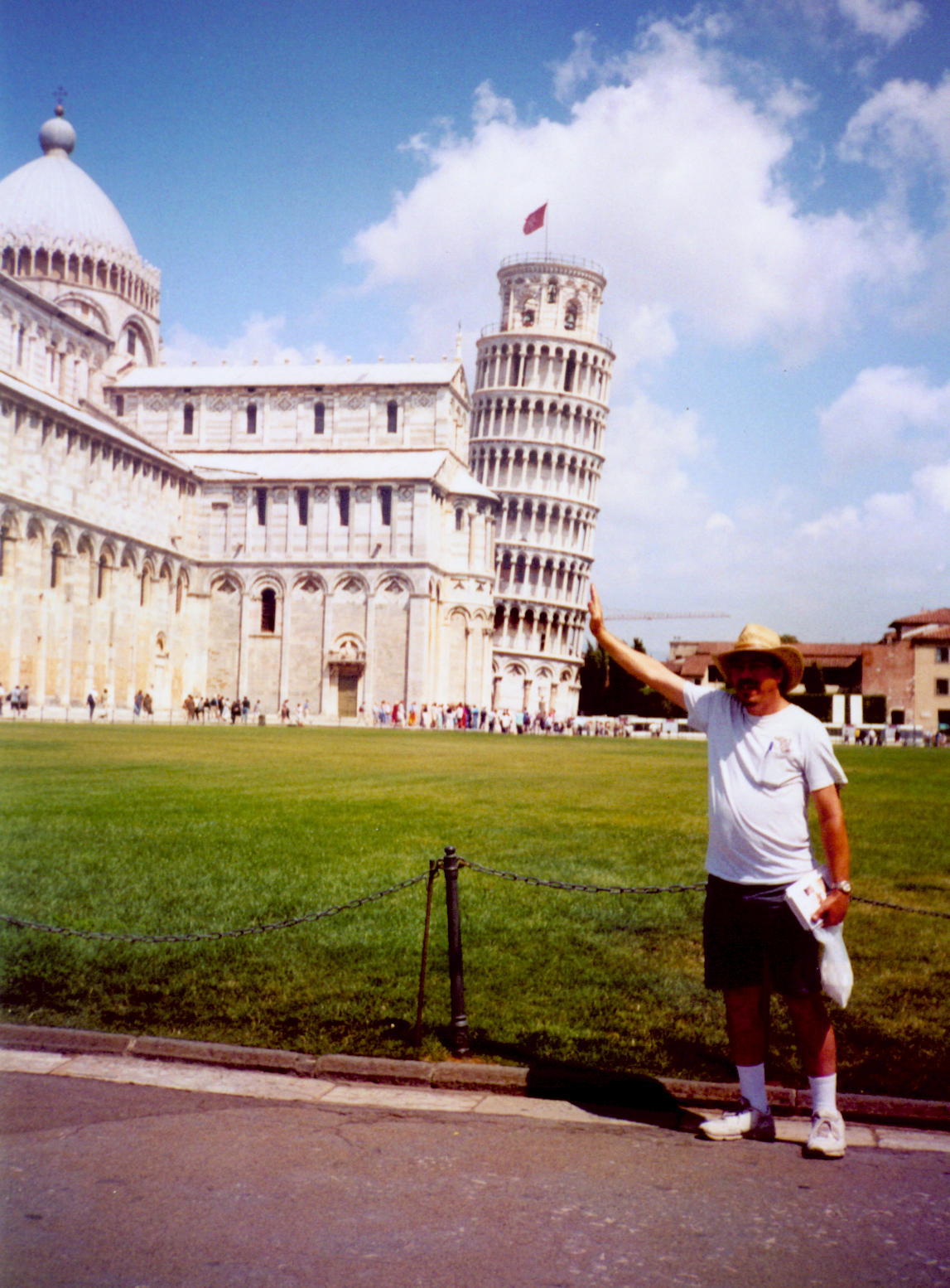 Gregg in Pisa, holding up the Leaning Tower