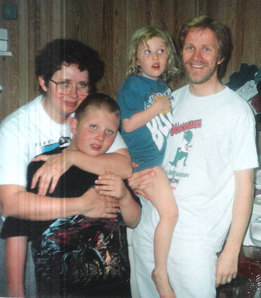 Cathy, Luke, Kate, and Jeff at the washer and dryer, talken by Shiela our foster child in April 1996