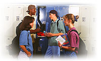 Image of four young people talking together in front of some lockers
