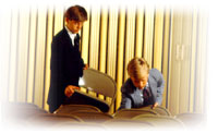 Image of two boys putting folding chairs away in a church building