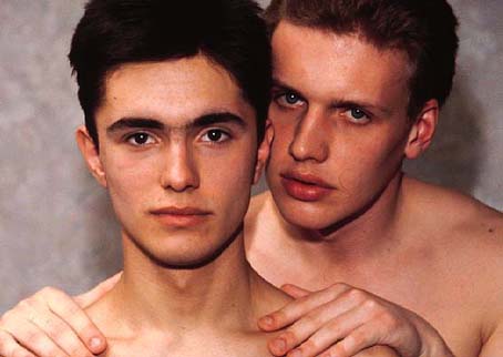 Head and shoulders view of two topless boys.