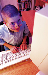 Child typing on computer
