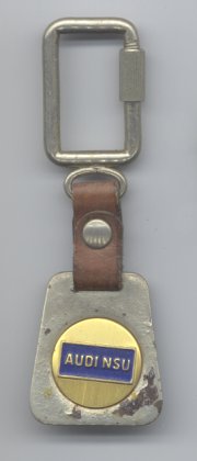 blue AUDI NSU logo on gold circle on grey trapezoid