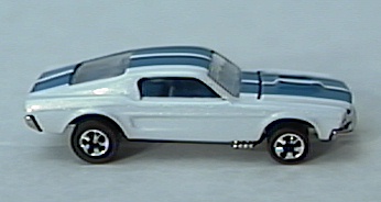 white '67 Mustang w/
redlines