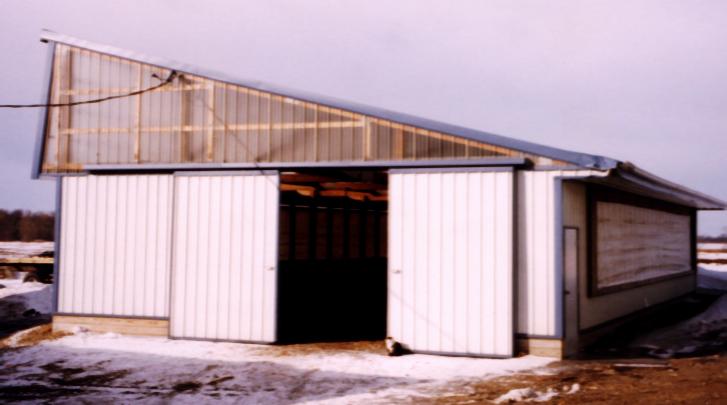 This is the new calf nursery where Sallie keeps the babies that will some day be milk cows.  With curtains on the north and south, the nursery is warm in the winter and cool in the summer.  Health and sanitation is very easily kept in this up-to-date baby condominium!