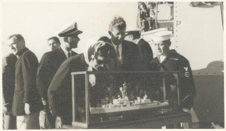 Mrs. Kennedy examines the carving