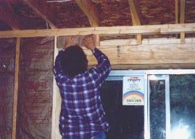 Mom putting up insulation