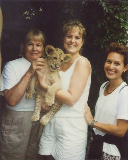 Alison Stringer (middle) and Renee Compton with Lion cub 
