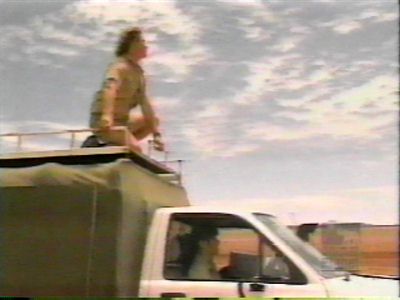 Steve on top of the truck driving through the outback