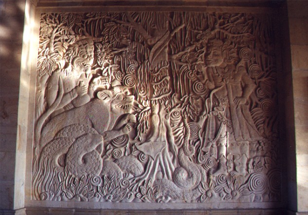 View of stone wall carving depicting 'The Priest Dharmeswami frees the Monkey, Tiger and Snake'