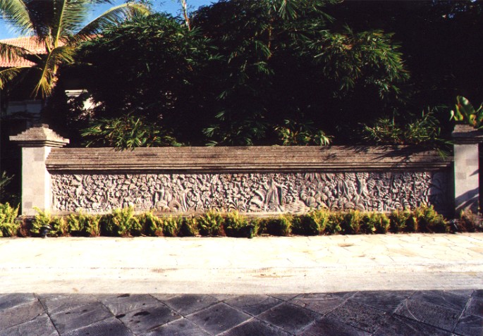 View of carved stone wall beside Porte Cochere of Le Meridien Hotel, Bali