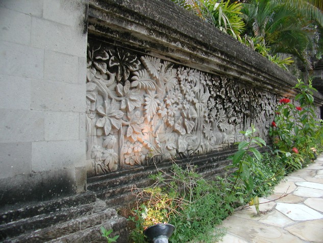 View of carved stone wall beside Porte Cochere of Le Meridien Hotel, Bali