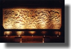 Night view from restaurant of stone wall carving