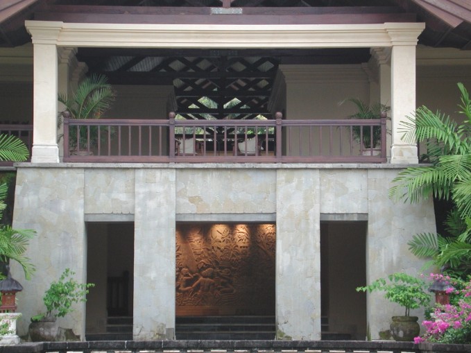 Click to view carved stone wall illuminated beyond.