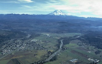 View SE toward Mount Rainier looming above Puyallup River valley
