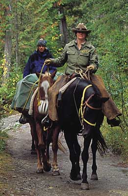The end of the trail -- A Paradise Mountain guide and guests return from a long day's ride exploring the resort wilderness areas.