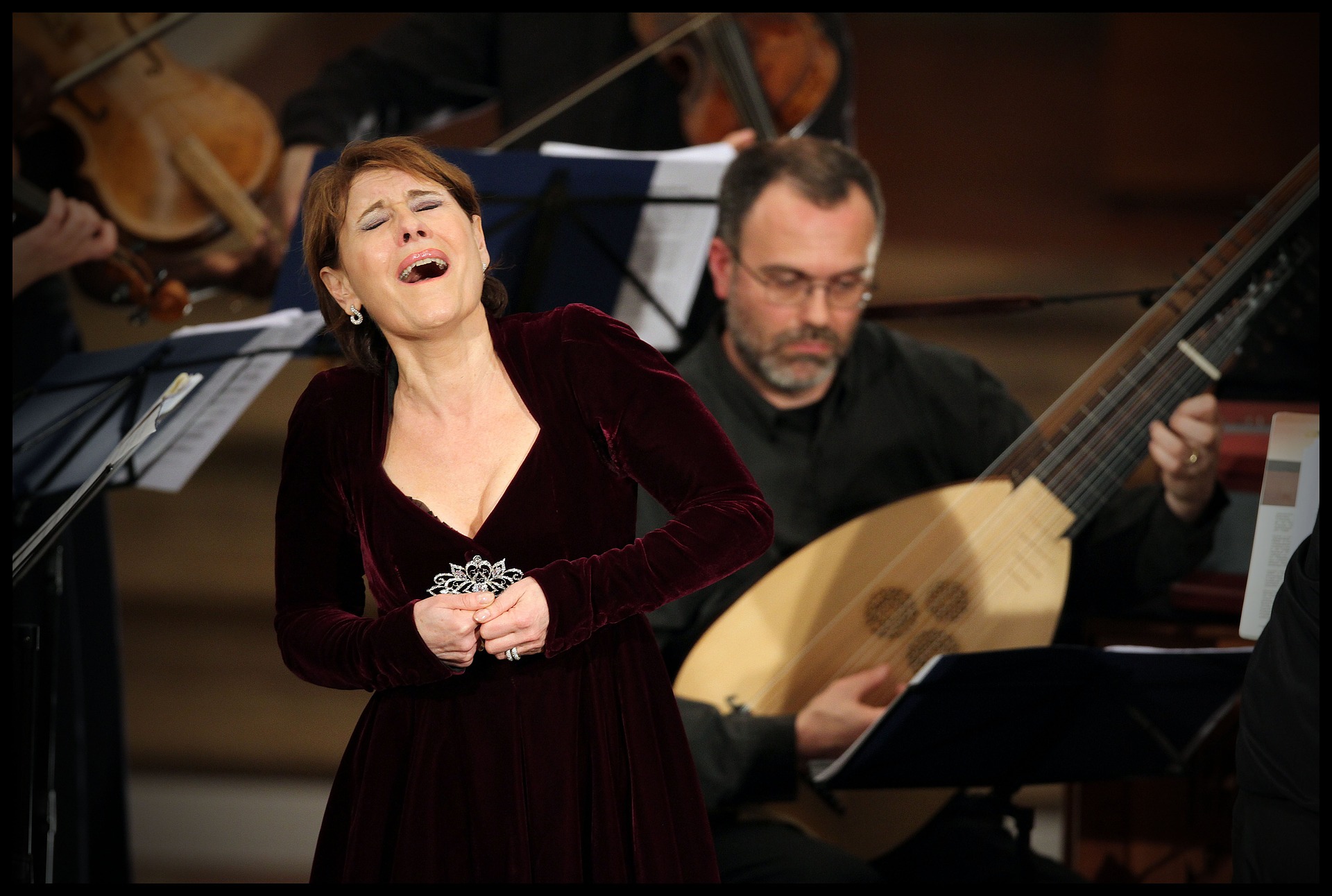 Woman singing in front of orchestra