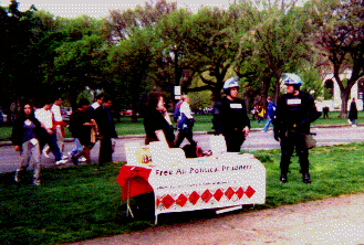 the sign reads: FREE ALL POLITICAL PRISONERS