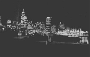 Jane runs through Portside Park with downtown Vancouver in the background