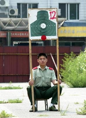 Captain in Chianese Military Police holding target above his head