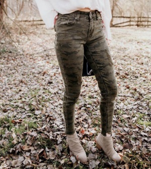 Brown camo boot cut jeans with slight rips in the thighs.