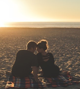 Picture of happy couple snuggling on sunset beach