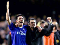 Chelsea manager Jose Mourinho runs onto the field and celebrates their victory after the final whistle