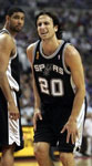 Ginobili grimaces as Duncan looks on concerned