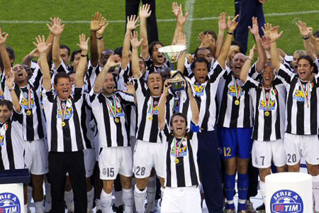Juventus captain Del Piero holds the Scudetto trophy aloft as the Juventus team raises their arms in celebration