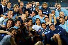 Lazio players and staff celebrate and pose with the Coppa Italia for the cameras.