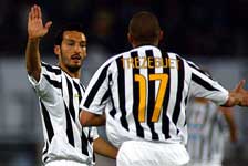 Zambrotta celebrates with Trezeguet after the France striker scores the opening goal
