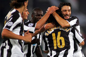 Camoranesi gets a hug from Zambrotta as Juventus celebrates his goal