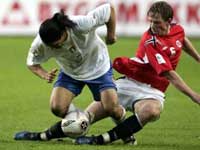 Camoranesi tackled by Norway's Jan Gunnar Solli