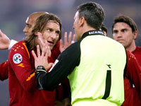 Roma captain Francesco Totti leads the protests against Juventus' penalty