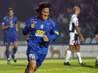 Camoranesi smiles after scoring from Del Piero's set piece
