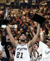 Duncan holds aloft the NBA Champions Trophy and his Finals MVP Trophy