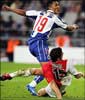 Porto's Carlos Alberto shoots as a  tackle from Monaco's Andreas Zikos comes flying in