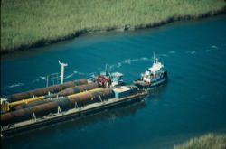 Barging on Inland Waterways project: A Barge pulled by a tug