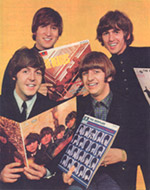 The Beatles with some of their earlier albums.