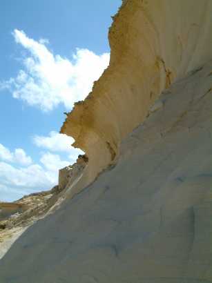 Strange cliffs by the salt-pans sculpted into the shape of a wave